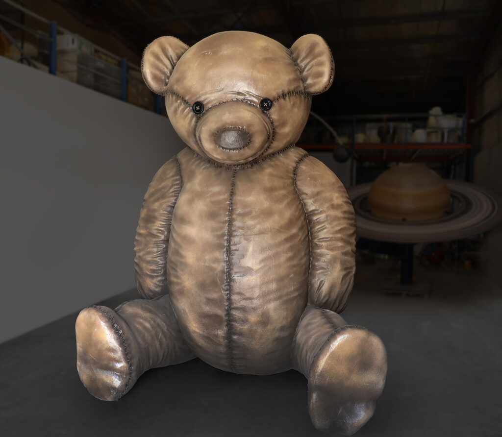 a giant stuffed teddy bear sitting on a table