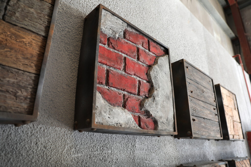 a brick and concrete art on a wall